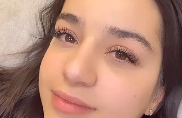 Client showing natural lash extension result by Blash